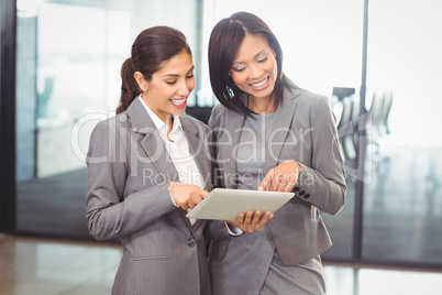 Businesswomen using digital tablet