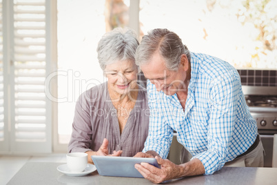 Happy senior couple using tablet