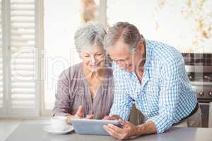 Happy senior couple using tablet