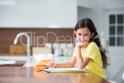 Portrait of smiling girl with hand on chin