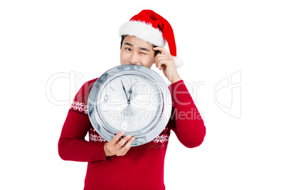 Happy young man holding stainless steel clock
