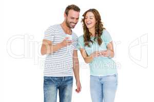 Happy young couple looking at mobile phone