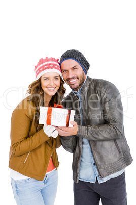 Happy young couple holding gift