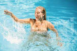 Beautiful woman enjoying in swimming pool