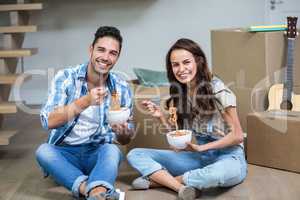 Portrait of Smiling couple having noodles