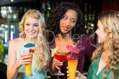 Happy friends drinking cocktails