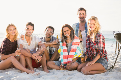 Friends drinking beer at the beach