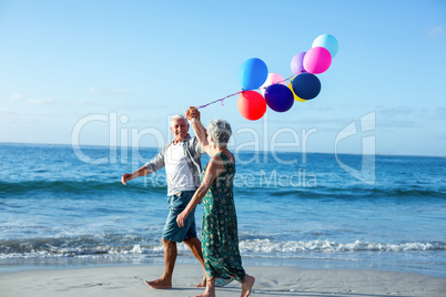 Senior couple holding balloons