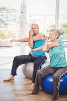 Portrait of senior man exercising with wife