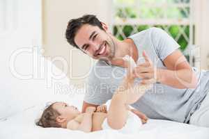 Portrait of smiling father playing with baby