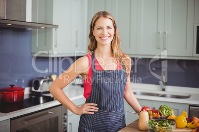 Portrait of smiling woman standing in kitchen Portrait of smiling woman standing in kitchen