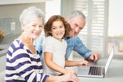 Portrait of happy girl with grandparents using laptop Portrait of happy girl with grandparents using laptop
