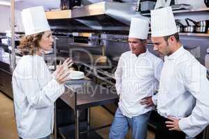 Upset head chef talking to her team