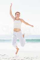 Carefree woman in jumping on the beach