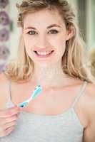 Portrait of happy woman brushing teeth