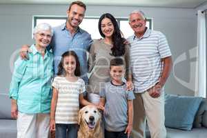 Family standing together with dog