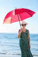 Senior woman posing with an umbrella