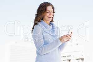 Happy young woman using mobile phone