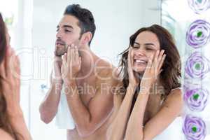 Young couple touching face in bathroom