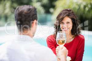 Portrait of smiling woman toasting white wine