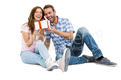 Happy young couple holding gift