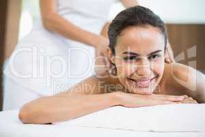 Portrait of woman smiling while receiving massage