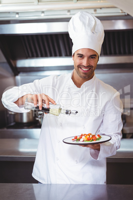 Chef putting finishing touch on salad