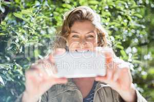 Smiling woman taking selfies