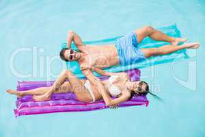 Cheerful couple relaxing on inflatable raft
