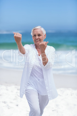 Beautiful mature woman practicing fighting sport