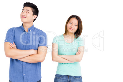 Young couple standing with arms crossed