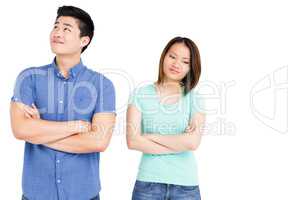 Young couple standing with arms crossed