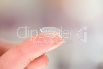 Cropped hand holding contact lens