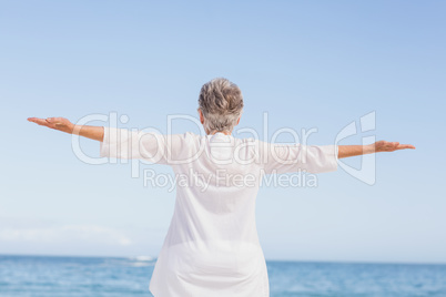 Casual senior woman with arms outstretched