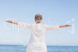 Casual senior woman with arms outstretched