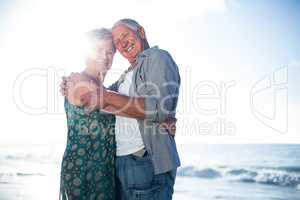 Senior couple embracing at the beach