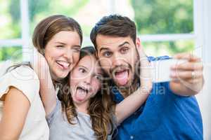 Happy family making faces while clicking selfie
