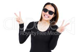 Woman in sunglasses making a v sign