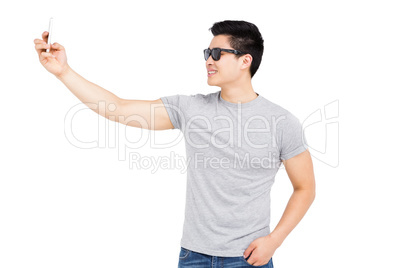 Young man taking a selfie on smartphone