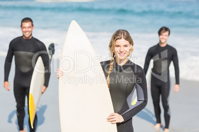 Portrait of surfer friends with surfboard standing on the beach