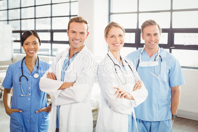 Happy medical team standing with arms crossed