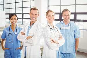 Happy medical team standing with arms crossed