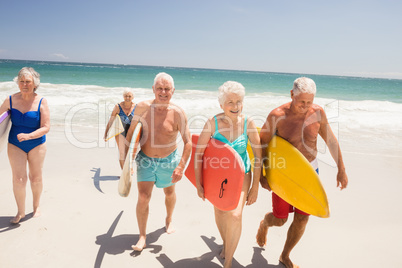 Senior friends holding surfboard