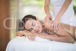Woman enjoying massage from female masseur