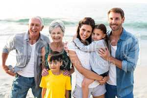 Happy family posing at the beach