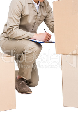 Delivery man counting cardboard boxes