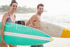 Couple with surfboard Walking on the beach