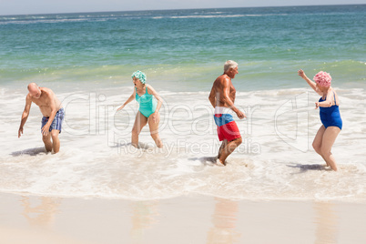 Senior friends playing in water