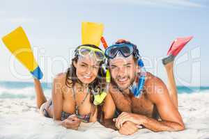 Couple wearing flippers at the beach