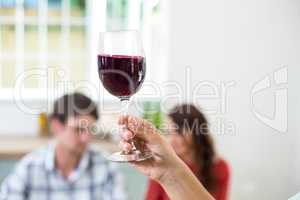 Cropped hand holding red wine glass